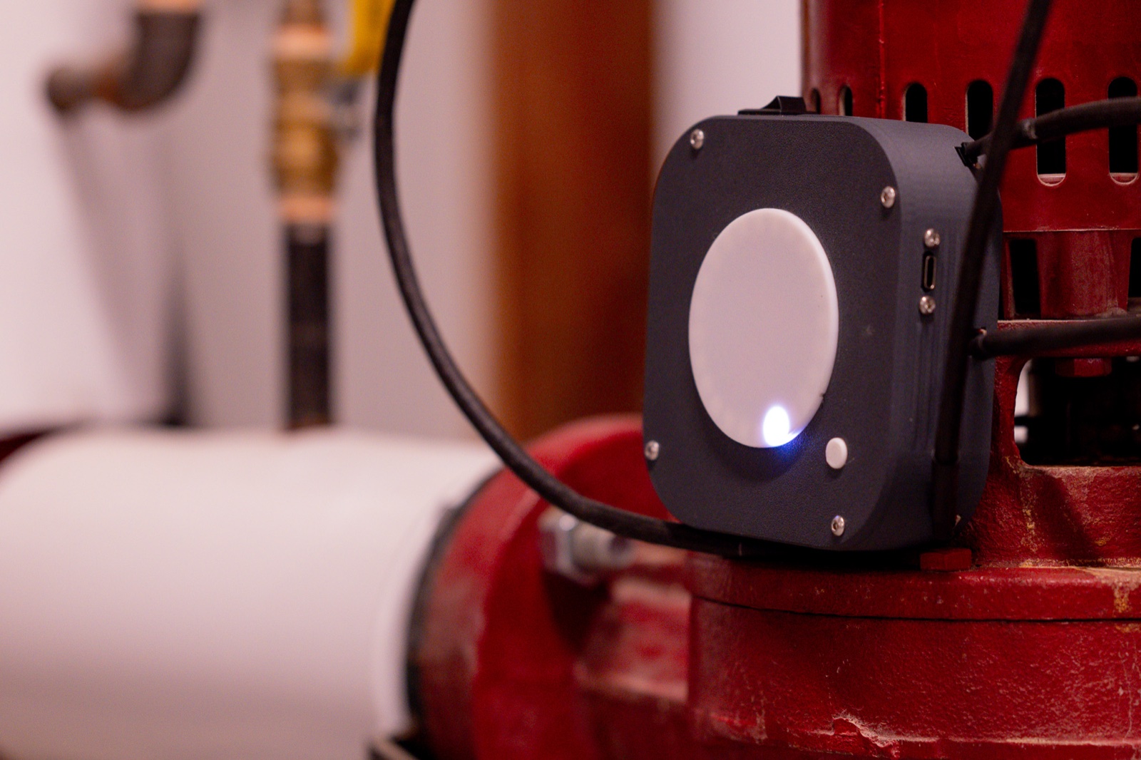 Custom industrial monitoring device deployed on production equipment — built by Atallis
