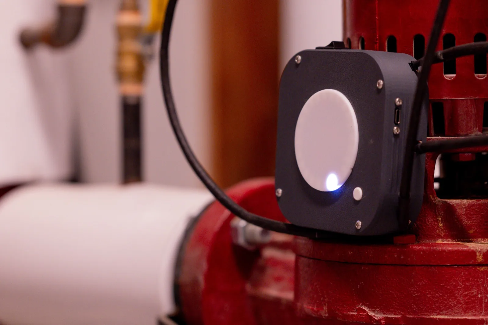 Custom industrial monitoring device deployed on production equipment, built by Atallis